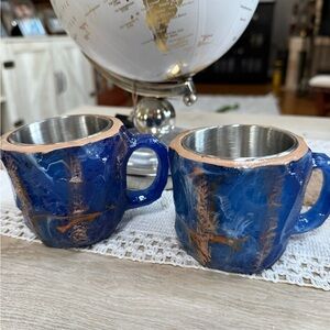 A Pair of a resin mineral crystal style mug with a stainless steel inner liner.